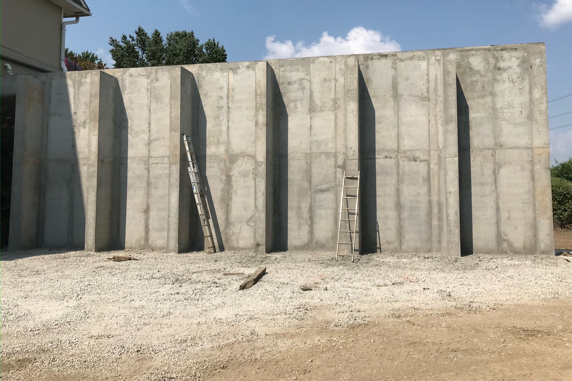 concrete wall with ladders against it