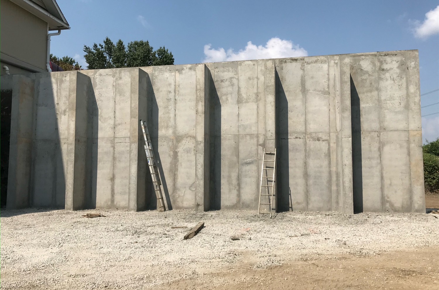concrete wall with ladders against it